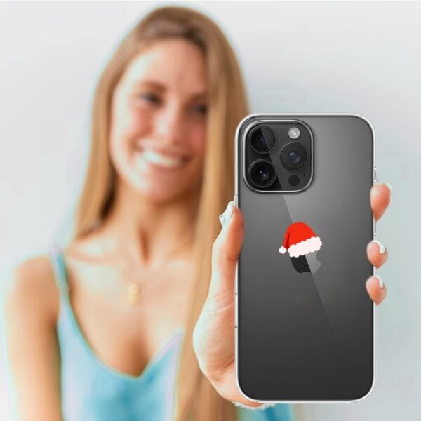 Etui do iPhone 16 Pro, czapka Mikołaja (4) Kobieta trzyma smartfon z naklejką Mikołaja.